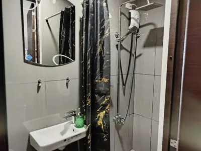 a bathroom with a sink and a shower at Modern-Studio with Balcony Stunning View in Manila