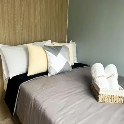 a bed with white pillows on it with at Crizzy's Hub Crizel at Shore Residences - 1BR with Balcony and Amenity view - Netflix and Disney - Near MOA in Manila