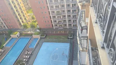 an overhead view of a swimming pool with tall buildings at Monarch Parksuites Balmoral Place Unit 1616 in Manila
