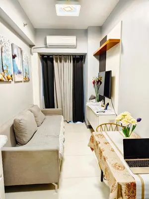 a small living room with a couch and a desk at Experience Unforgettable Moments in Manila