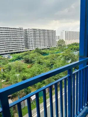 a balcony with a view of a city with tall buildings at Sea Residence By Kenshin Staycation in Manila