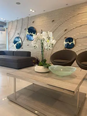 a living room with a table with a vase on it at Sea Residence By Kenshin Staycation in Manila