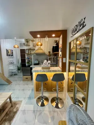 a kitchen with two bar stools and a counter at Binangonan Primes Tiny Home with FREE breakfast and Plunge Pool in Binangonan