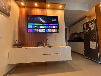 a tv hanging on a wall in a kitchen at S Residences, Tower-3 in Manila