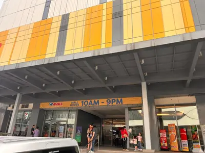 a building with people walking in front of a store at S Residences, Tower-3 in Manila