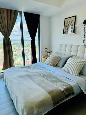 a bedroom with a large bed with a large window at Cornelia Street at Azure Urban Resort Residences in Manila