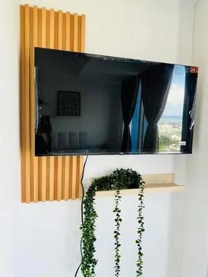 a mirror hanging on a wall with a plant at Cornelia Street at Azure Urban Resort Residences in Manila