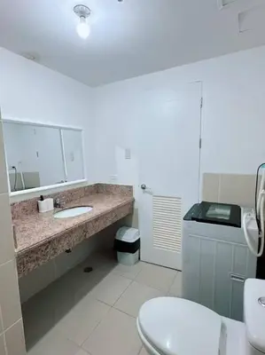 a bathroom with a sink and a toilet at Tan condo fairway in Manila