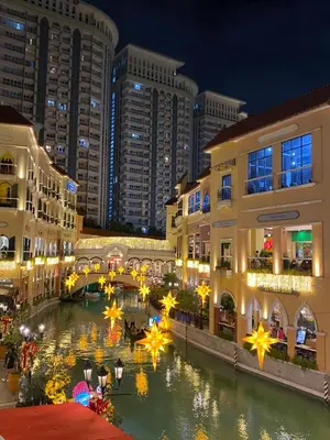 a view of a city at night with buildings at JL Suite Staycation near Venice Grand Canal Mall in Manila