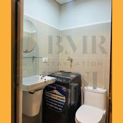 a small bathroom with a toilet and a sink at Staycation Manila at Coast Residences in Manila