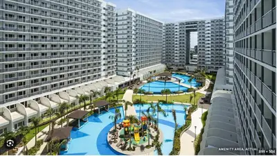 an overhead view of a large swimming pool with buildings at Unistay SHELL Residence Amazing pool near MOA in Manila
