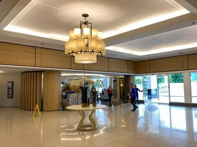 a large lobby with a table and a chandelier at Unistay SHELL Residence Amazing pool near MOA in Manila