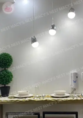 a table with plates and glasses and lights on the wall at Macy's Nest - Shore 2 Tower 1 in Manila