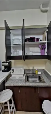 a kitchen with a sink and a counter top at 21K Pioneer Woodlands Mandaluyong in Manila