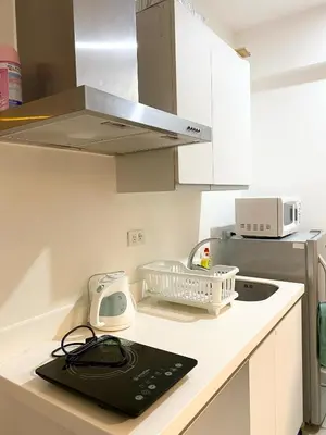a kitchen with a counter with a sink and a microwave at Azure Staycation by Casa Lepap in Manila