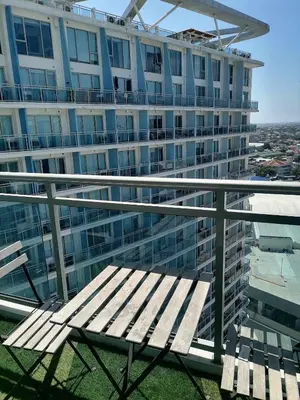 a wooden bench sitting on top of a building at Luxury 1Bedroom Condo Unit Near Manila Airport - Azure Resort Residences in Manila