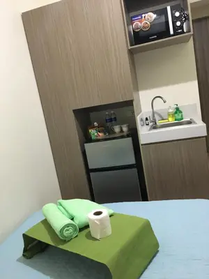 a kitchen with a sink and a table with a roll of toilet paper at Studio in the Metro I Near MRT I WiFi in Manila