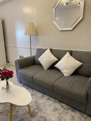 a living room with a couch and a mirror at shore residences 1 -City Spark staycation in Manila