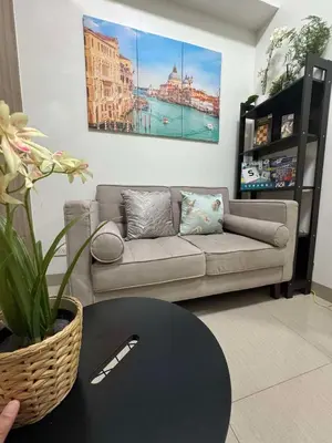 a living room with a couch and a table at Shore 2 Residences Tower 1 in Manila