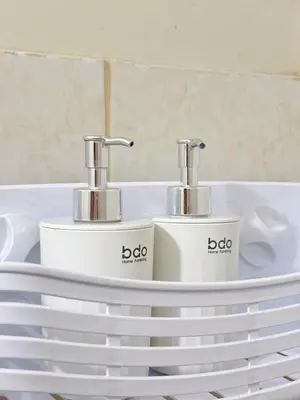 a sink with two faucets on top of a plate at Cozy 2BR Condo Free Pool Access in Manila