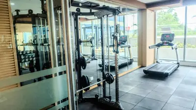 a gym with several tread machines in a room at Novel Hotel Manila in Manila