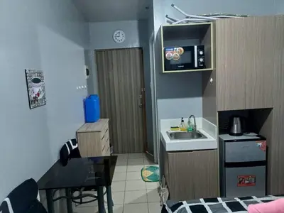 a small kitchen with a sink and a table at Berto's Staycation Long Term and Short Term in Manila