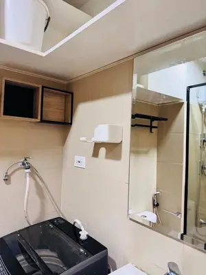 a bathroom with a sink and a mirror at hearth of ember 3 Shore 3 Res in Manila