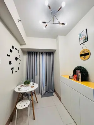 a kitchen with a small white table and chairs at hearth of ember 3 Shore 3 Res in Manila