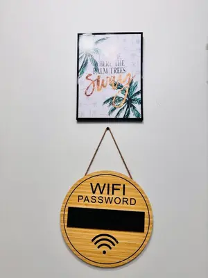 a sign that reads wifi password hanging on a wall at hearth of ember 3 Shore 3 Res in Manila