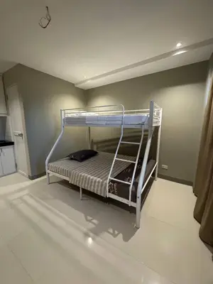 a bedroom with a bunk bed in a room at Santipha Residences in Manila