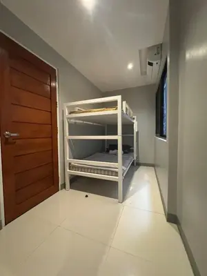 a bedroom with a bunk bed in a room at Santipha Residences in Manila