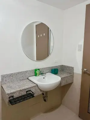a bathroom counter with a sink and a mirror at Alea Residence 21 in Manila