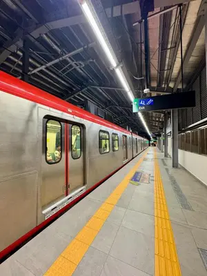 a subway train in a subway station with a platform at 2BR Condo Staycation NearAirport in Manila