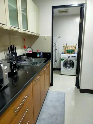 a kitchen with a sink and a washing machine at Your HOME away from home in Manila