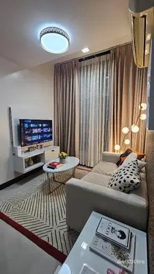 a living room with a couch and a tv at Your HOME away from home in Manila