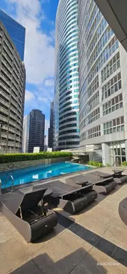 a swimming pool in a city with tall buildings at Your HOME away from home in Manila