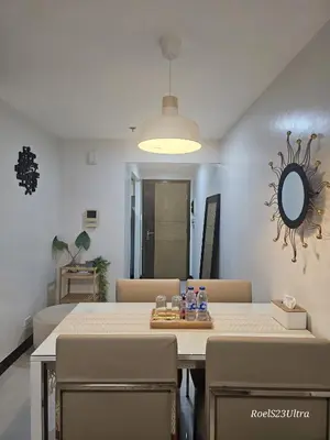 a dining room with a table and chairs and a mirror at Your HOME away from home in Manila