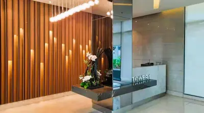 a lobby with a wall of wooden panels and flowers at Charles Haven's Crib - Spring Residences in Manila