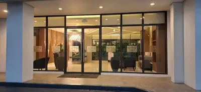 a store front with black chairs in a building at Charles Haven's Crib - Spring Residences in Manila