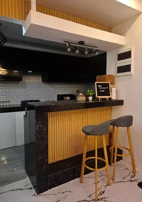 a kitchen with two bar stools at a counter at Phoenix Bliss - Amber in General Trias