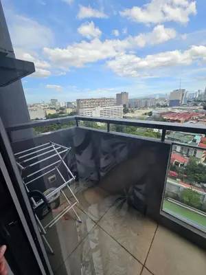 a balcony with a view of a city at Unit 14E Tower D, 1BR Unit- Manhattan Heights Cubao in Manila