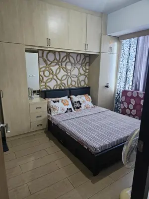 a small bedroom with a bed and a dresser at Unit 14E Tower D, 1BR Unit- Manhattan Heights Cubao in Manila