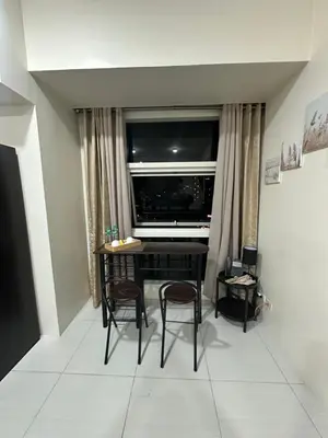 a room with a table and two chairs and a window at Lugar Kalinaw in Manila