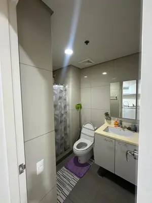 a bathroom with a toilet and a sink at Lugar Kalinaw in Manila