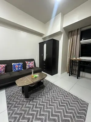 a living room with a couch and a coffee table at Lugar Kalinaw in Manila