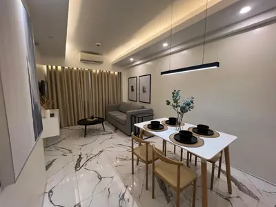 a living room with a table and chairs at Newport City Rentals in Manila