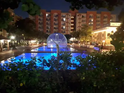 a fountain in the middle of a street at night at The Teal Deal in Manila