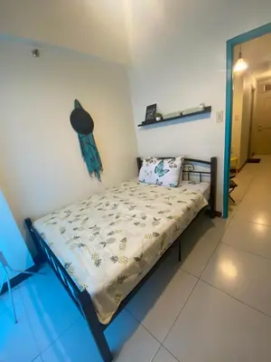 a small bed in a room with at The Teal Deal in Manila