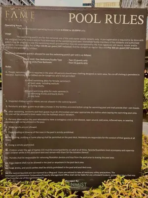 a sign for a game of pool rules at Royal Fame Residency in Manila