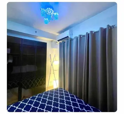 a room with a shower and a bed with curtains at SHORE 2n3 RESIDENCES in Manila